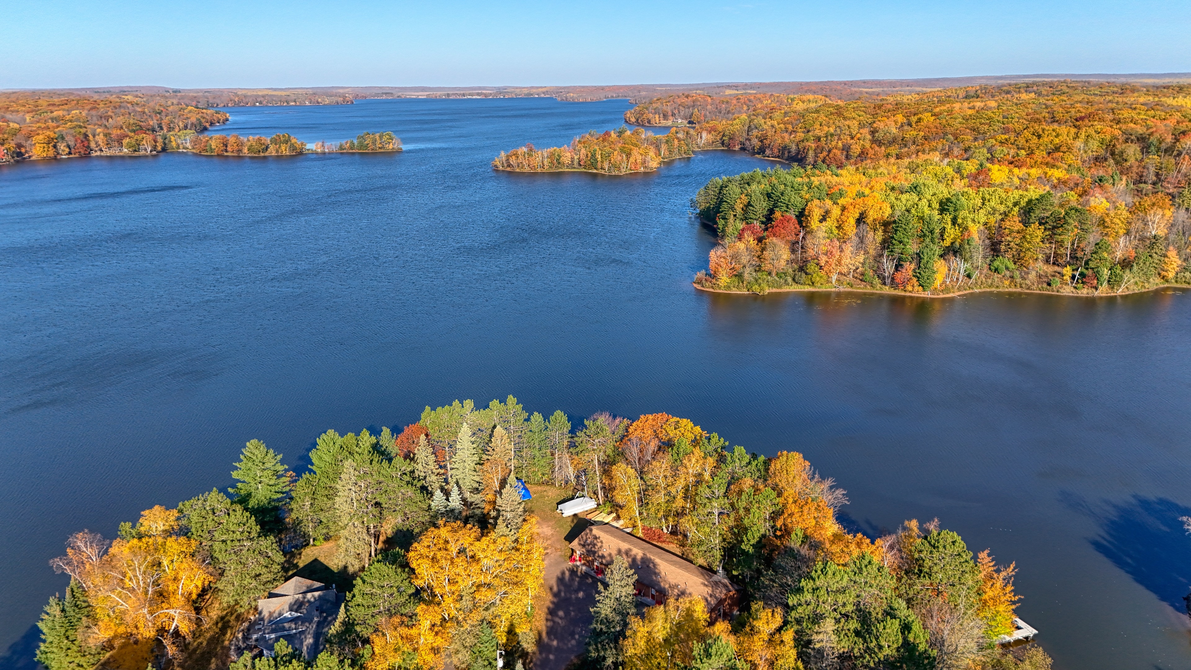 Aerial view of lakefront property with forested islands in peak autumn color, Northern Wisconsin